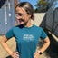 A young Lady showing wearing a blue Skin Ski + Surf Shirt