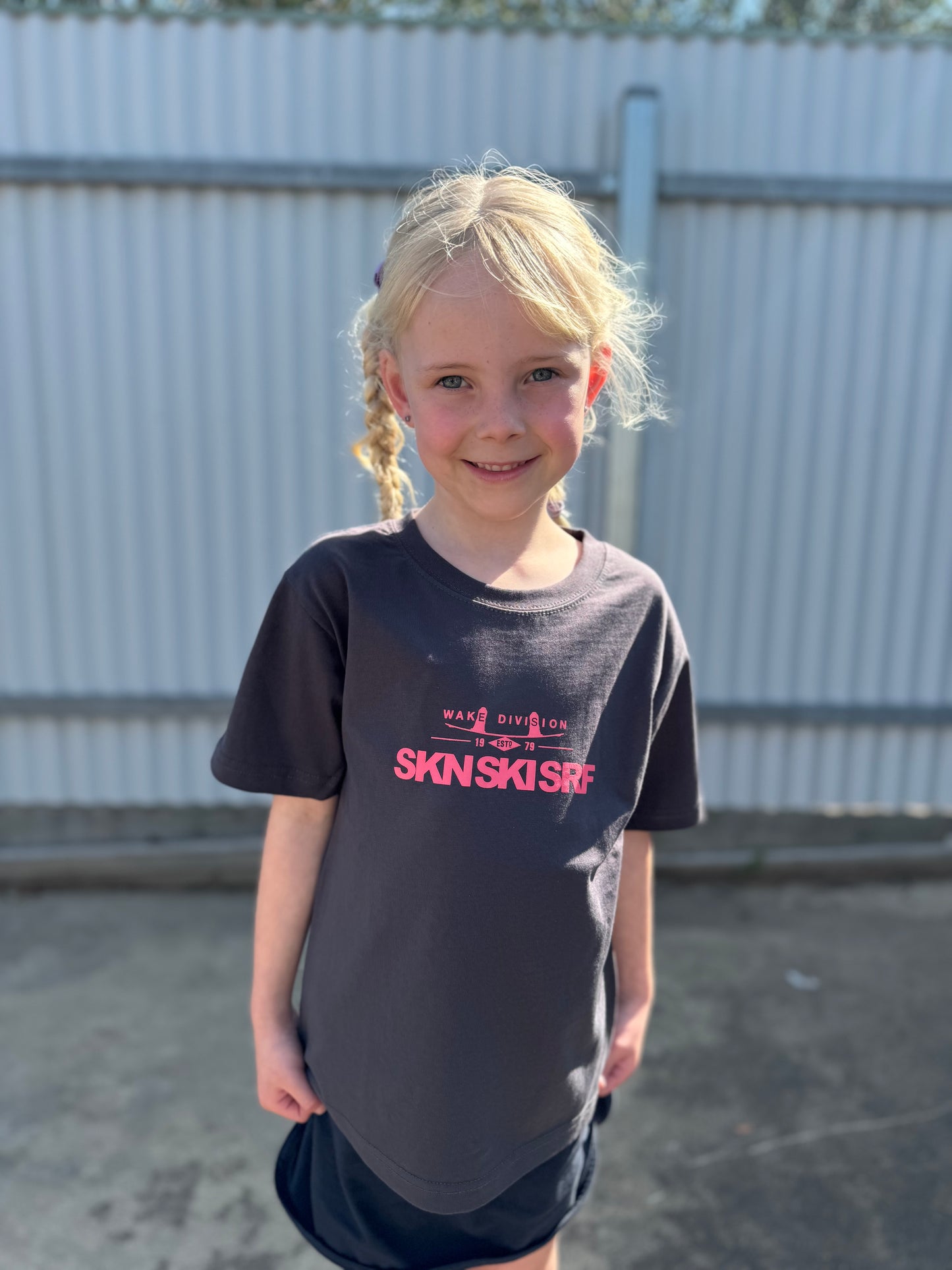 the front side of a young girl in a wakeboard division t shirt