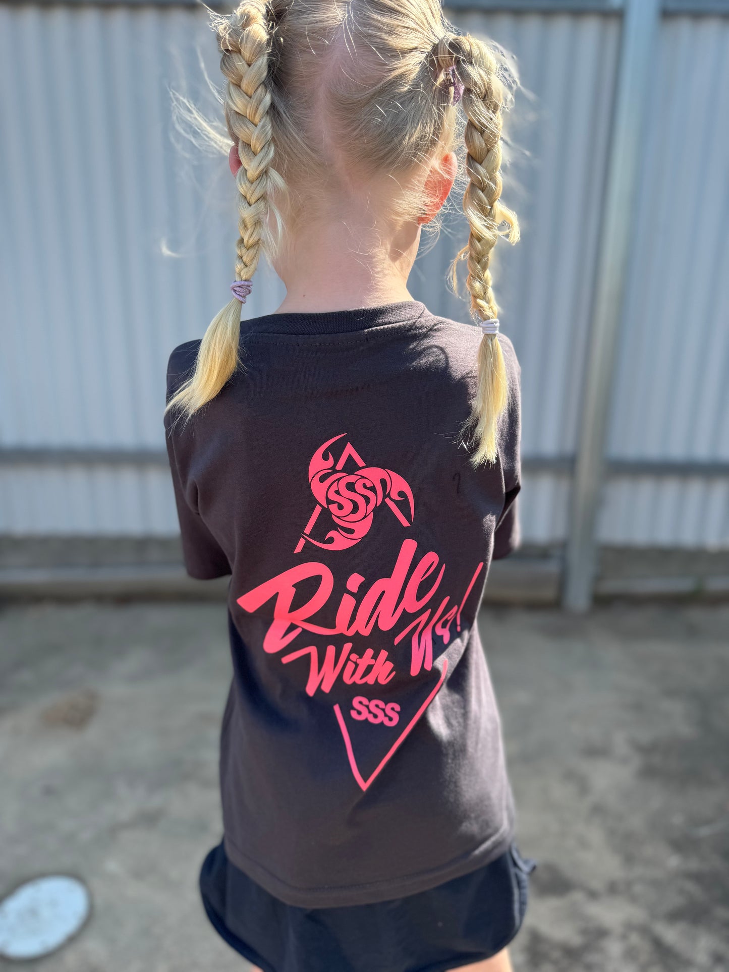 the front side of a young girl in a wakeboard division t shirt